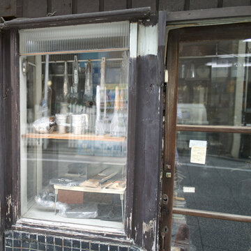 intage Japanese storefront window with a close sign and traditional kitchenware