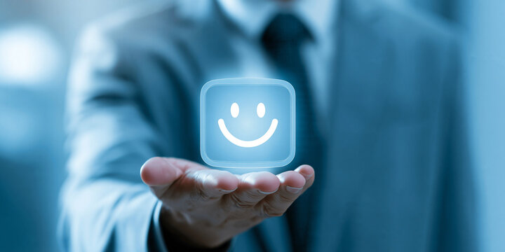A person in a suit holds out their hand, displaying a glowing smiley face icon, symbolizing positive customer feedback or a good experience