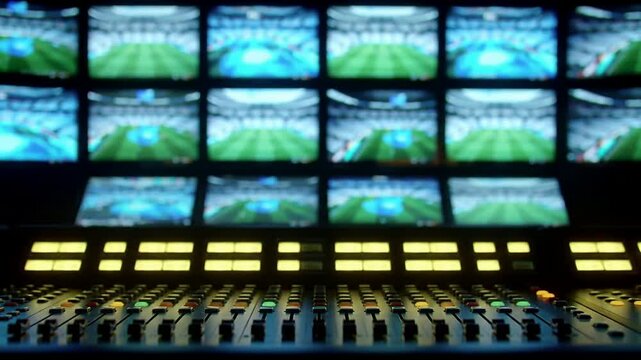 High-Tech Sports Venue Control Room with Multiple Monitors and Console for Live Broadcasting and Media Production