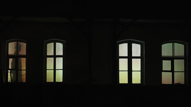 People in the windows at night