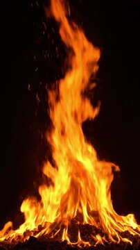 Realistic fireplace fire with constant flame height and flying sparks on a dark background