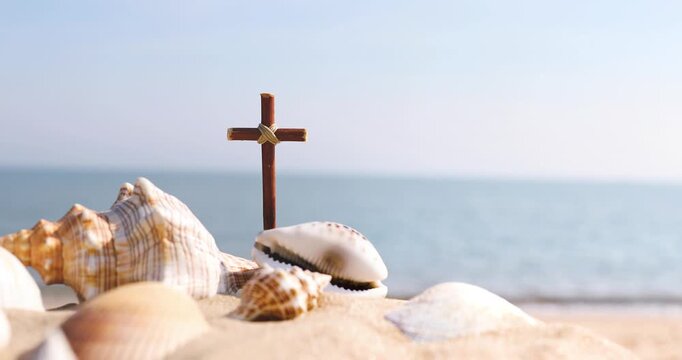 A cross on a wave-crashing beach, a church summer retreat and summer Bible school with seashells and conch shells on the sand, background of the sound of waves and summer camp.
