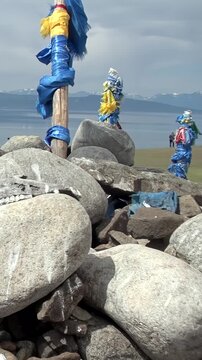 Witness sacred traditions at an ancient ovoo shrine by Lake Khuvsgul in the majestic mountains of Mongolia. This spiritual daytime landscape emanates profound peace and natural beauty.