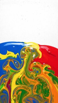 Vibrant thick paint colors swirling and blending into an abstract pattern on white background