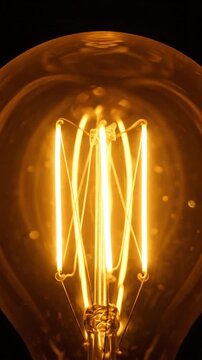 Vintage Edison light bulb filament glowing against a dark background for creative concepts