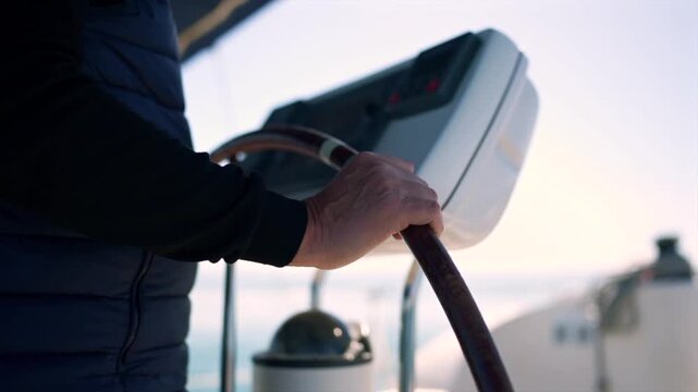 Captain steering sailboat helm on ocean voyage