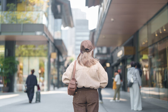 woman traveler travel in Chengdu city. Happy Tourist sightseeing in Taikoo Li Chengdu, located in the Jinjiang District, near the Chunxi Road. Famous landmark for tourism attraction in Sichuan, China