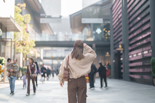 woman traveler travel in Chengdu city. Happy Tourist sightseeing in Taikoo Li Chengdu, located in the Jinjiang District, near the Chunxi Road. Famous landmark for tourism attraction in Sichuan, China