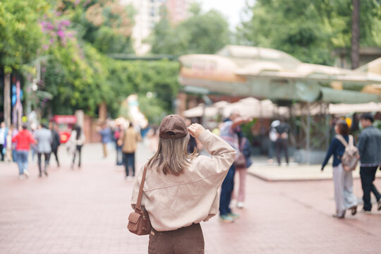 Happy woman traveler travel in Chengdu city. Tourist sightseeing and shopping in Eastern Suburb Memory or Dongjiao Ji Yi. Famous Landmark for tourism attraction in Sichuan, China