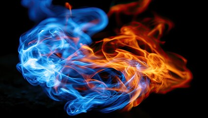 Fototapeta premium Wisps of blue and orange flame dance in a swirling, ethereal display against darkness