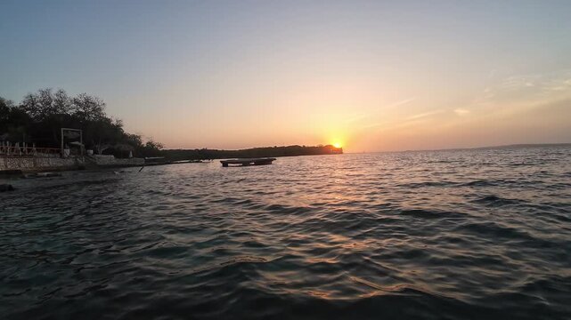 Scenic ocean sunset with golden light reflecting on water
