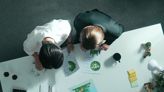 Top aerial view of businessman and manager talking about clean energy investment. Aerial view of business team working together planning to use renewable energy. ESG modern development. Alimentation.