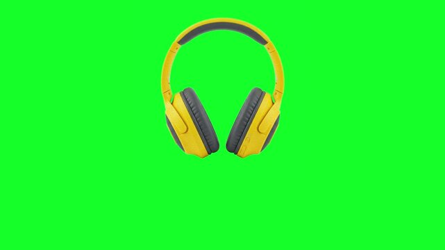 Animated modern yellow wireless headphones falling from the top on a green screen chroma key background. Realistic 3D over-ear audio headset dropping down animation loop for tech product advertisement