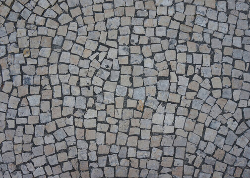 Portuguese cobblestone pavement texture in Braga Portugal, stone mosaic background  