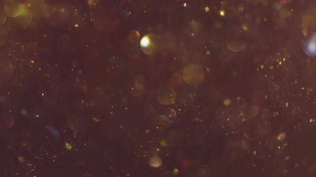 Radiant sparkling blur. Color bokeh blink. Yellow shimmering snow stream on purple abstract background. Flicker circles reflection mix.