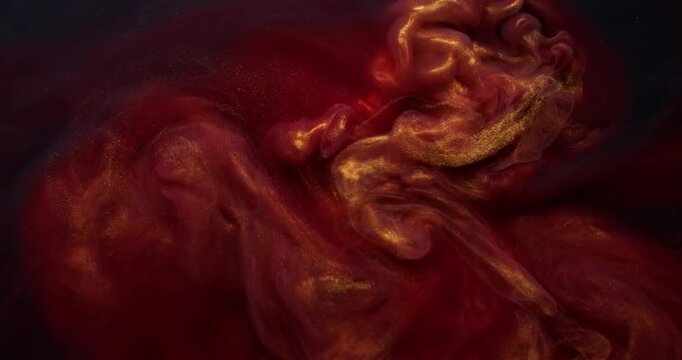 Sparkling ink blend. Dust fluid. Shimmering metallic particles paint golden red smoke flow. Mysterious color mix splash blur abstract background.