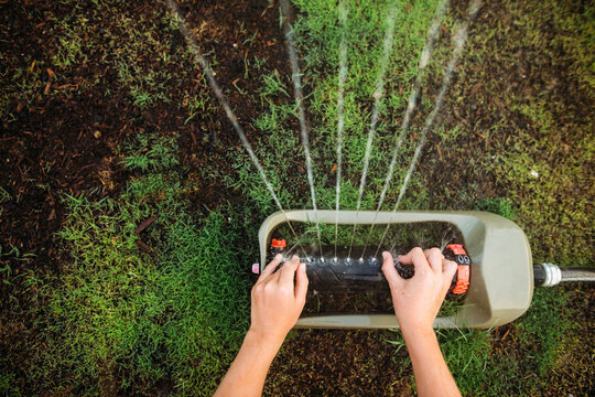 Hands in sprinkler