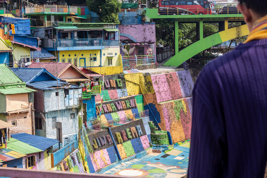 a young man with glasses and scraf in "colorfull" vilage in Malang