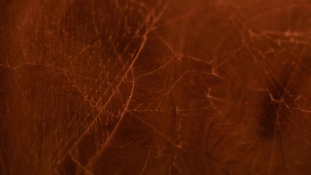 Steam haze. Broken window. Defocused orange color smoke vapor hot fragile texture smog mist scratched glass on abstract uneven art background.