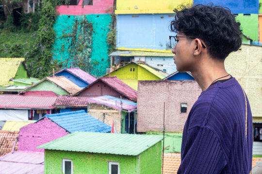 a young man with glasses accessoriesin the "colorful" village of Malang