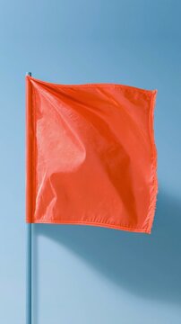 Weathered red warning flag on a pole signifies hurricane preparation and coastal weather alerts for editorial news and safety notices