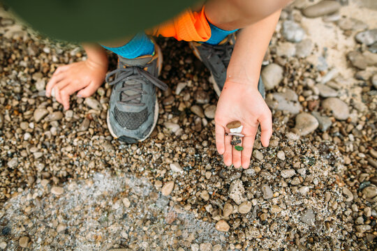Boy holding rocks and sea glass