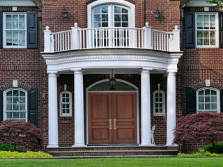 Fototapeta premium House with elegant portico entrance and wood grain double front door