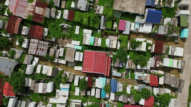 Top view drone footage of Alfonso Public Cemetery in Alfonso Cavite Philippines revealing the geometric arrangement of graves, pathways, and open areas.