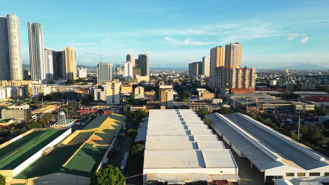 Forward aerial shot passing by above Mercury Group of Companies Incorporated Factory and high buildings at Shaw Boulevard corner Pioneer Street, Pasig City Metro Manila Philippines during daylight.