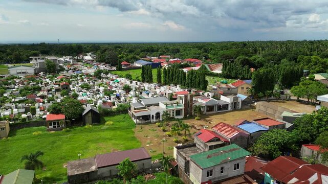 Wide establishing aerial shot of Alfonso Public Cemetery in Alfonso Cavite Philippines showcasing the cemetery grounds, surrounding roads, and nearby provincial landscape during daytime.
