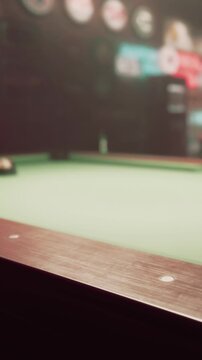 At a local pool hall, players gather around a green billiards table. The atmosphere is lively as they aim for the balls. The dim lights create a relaxed setting for the game.