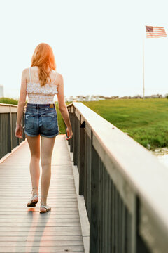 Teen girl walking on bridge