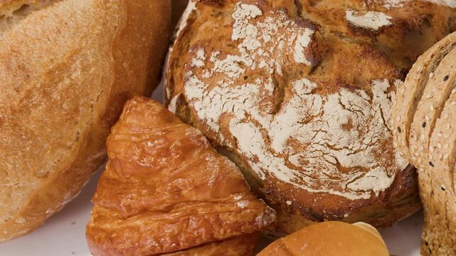 Assorted Fresh Bakery Breads and Pastries on White Background