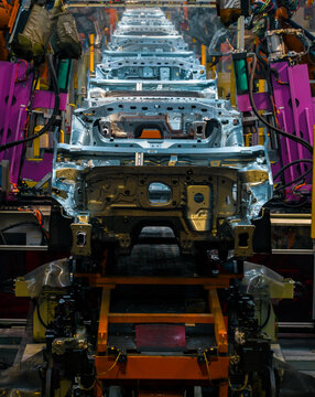 Robotic arms are welding points on the car body on an automated production line.