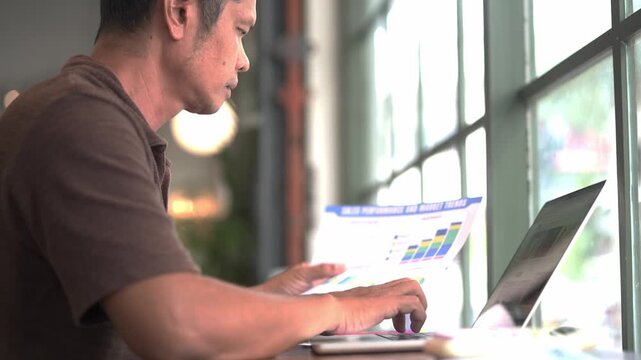 Hispanic Businessman Working on Laptop Computer in Modern Office, Smiling Professional Using Technology for Online Work, Internet Research, Digital Business and Casual Workplace Lifestyle Concept
