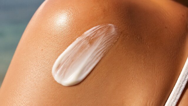 Shoulder skin with cream applied in closeup body shot
