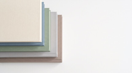 Fototapeta premium Five pastel hardcover books spread on white background with large copy space