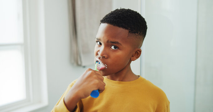 Dental hygiene, portrait and black child brushing teeth in bathroom for health, wellness or morning. Toothbrush, oral care and boy kid with clean mouth for fresh breath or grooming routine in house.