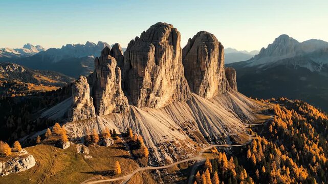 Stunning Tre Cime peaks with golden autumn larches at sunset, perfect for travel and nature content.