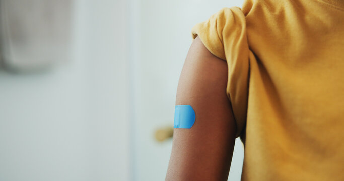 Medical, arm and kid with plaster, flu vaccine and virus prevention for childhood development. Healthcare, space and boy with wound bandage, immunization shot and disease protection in child growth.