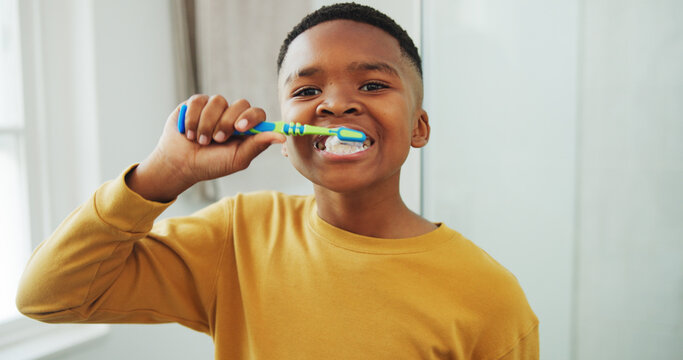 Dental health, portrait and black child brushing teeth in bathroom for hygiene, wellness or morning. Toothbrush, oral care and boy kid with clean mouth for fresh breath or grooming routine in house.