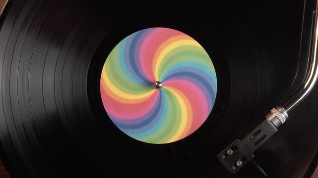 Spinning Vinyl Record With Rainbow Sticker, Close Up Top Down View