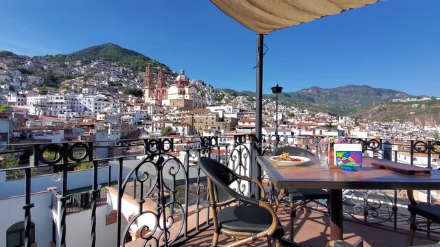 View of the historic Santa Prisca Church and colonial architecture from a terrace in Taxco, Guerrero, Mexico.