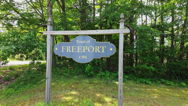 Freeport Maine 1789 welcome sign backed by summer forest