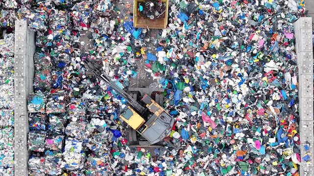 Processing plastic waste at recycling facility with industrial machinery