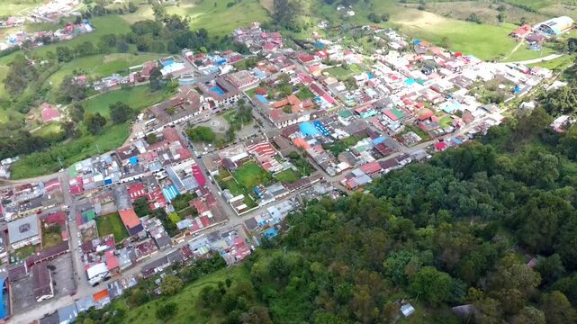 Aerial view of the small town of zipacon in cundinamarca, colombia, surrounded by green mountains
