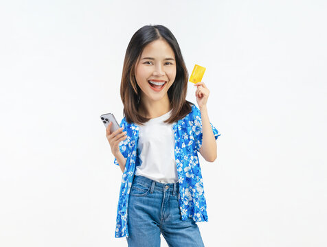 Happy young Asian woman holding smartphone and credit card, mobile payment and online shopping concept