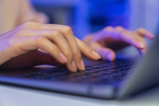 Hands typing on laptop keyboard on table, remote working and digital business technology concept.