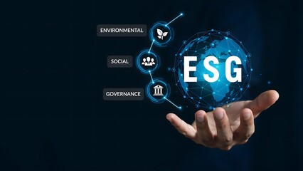 Obraz premium Hand Presenting Glowing ESG Globe with Environmental Social and Governance Icons
