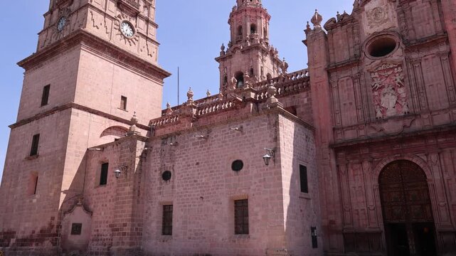 View of the historic Morelia Cathedral with its iconic pink stone facade and ornate towers in the city center of Morelia, Michoacan, Mexico.